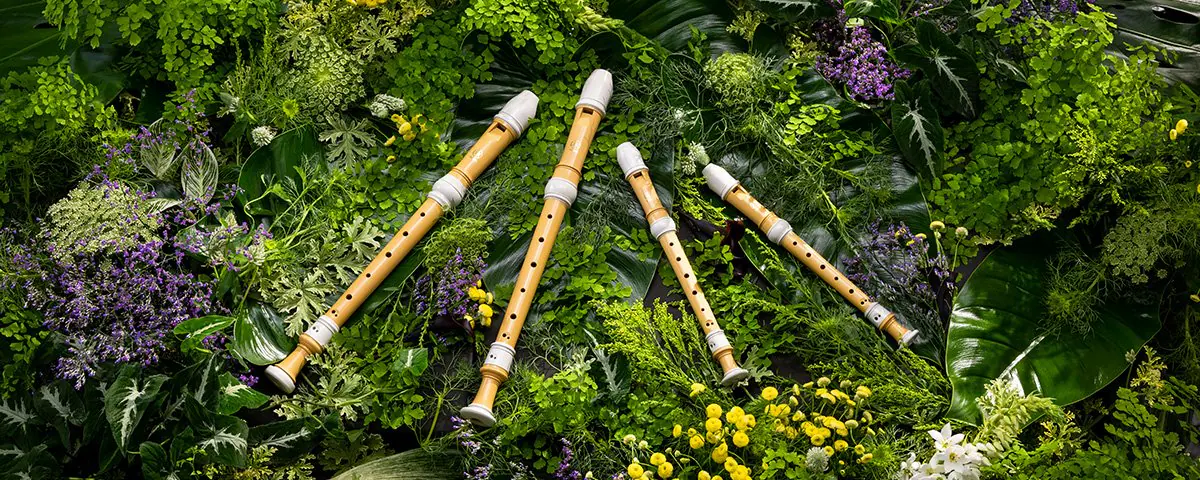 Yamaha's plant-based recorders on a woodland floor, surrounded by greenery and flowers